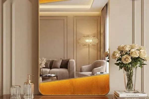 A large mirror in a room with a brown frame and a glass top.
