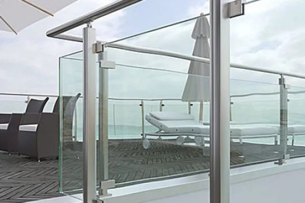 A silver framed glass balcony railing with a metal frame and a clear glass panel.