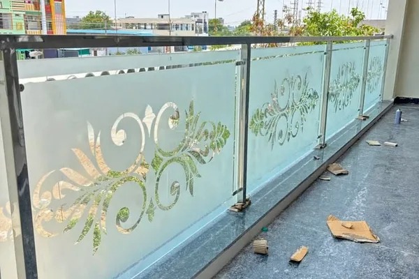A balcony with a glass railing and a metal frame.