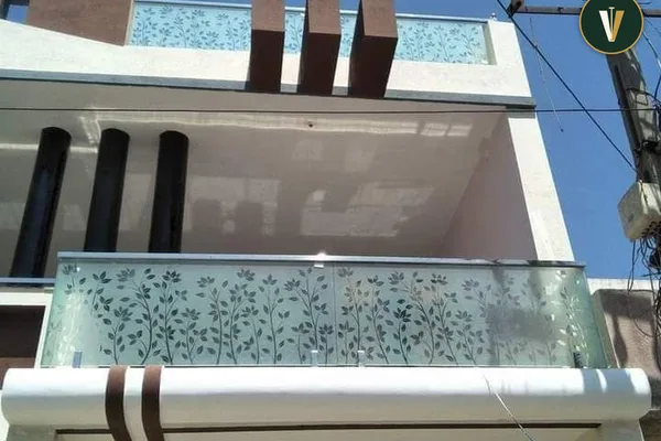 A glass balcony railing with a white frame.