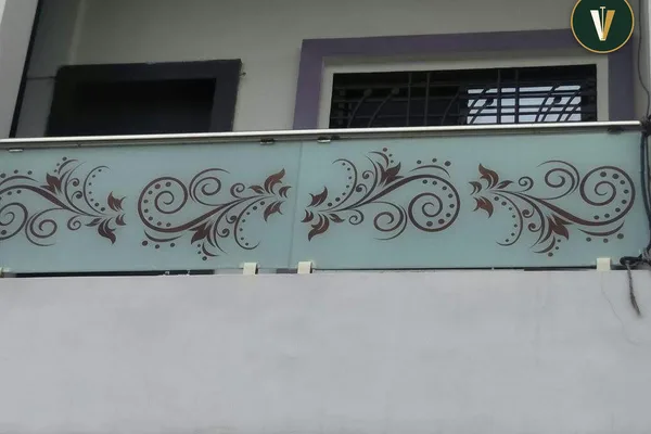 A glass balcony railing with a curved design.