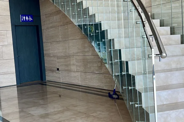 A glass and metal staircase with a curved design.