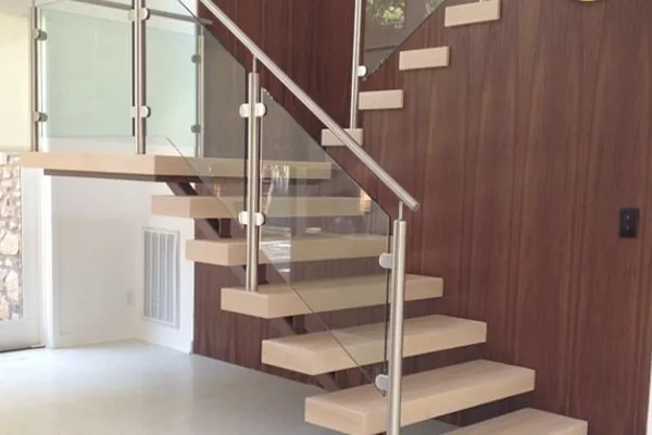 A metal glass staircase with a clear glass railing.