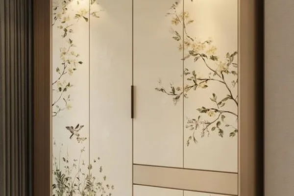 A large white wardrobe with a glass door and a design of flowers on it.